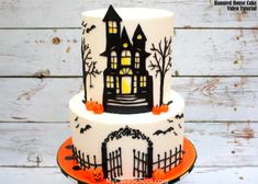 a three tiered halloween cake decorated with black and white icing, pumpkins and bats