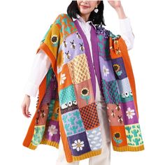 a woman wearing a multicolored knitted shawl with flowers and bees on it