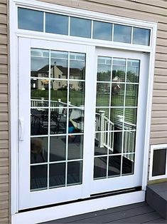 the front door to a house with sliding glass doors on both sides and an outside deck