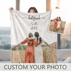 two women holding up a personalized photo blanket