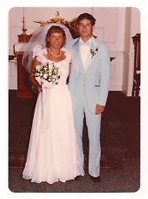 a man and woman dressed in wedding attire