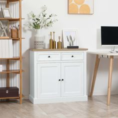 a desk with a computer on top of it next to a bookcase and shelves