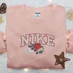 Introducing the Rose x Nike Embroidered Sweatshirt, a perfect blend of style and comfort. This sweatshirt features delicate rose embroidery Pink Cotton Sweatshirt With Floral Embroidery, Casual Pink Sweatshirt With Floral Embroidery, Pink Long Sleeve Sweatshirt With Floral Embroidery, Nike Embroidered Sweatshirt, Floral Nikes, Nike Inspired, Sweatshirt Ideas, Embroidered Apparel, Unique Floral Design