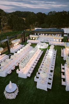 an aerial view of a wedding setup with white tables and chairs set up for the reception