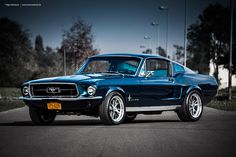 an old mustang is parked on the street