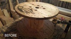 a round wooden table sitting on top of a hard wood floor