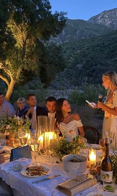 a group of people sitting around a dinner table