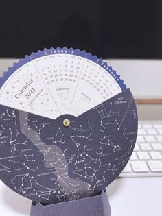 a paper clock sitting on top of a computer keyboard