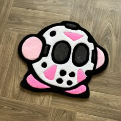 a black and pink rug with a cartoon dog on it's face, sitting on the floor