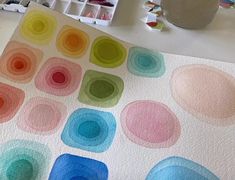 a painting is being made with watercolors on paper