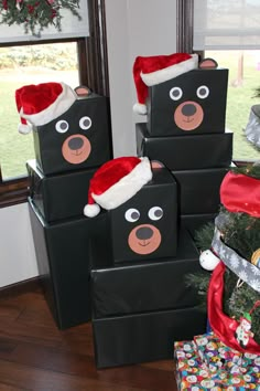 some black boxes with christmas hats on them