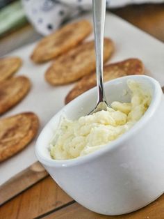 a spoon in a bowl filled with mashed potatoes