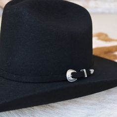 Featuring the iconic Cattleman crease crown, this cowboy hat is accented with a self-band and a three-piece silver buckle. It's designed with a leather sweatband for comfort and a satin lining in the crown. 4" brim 4 1/4" crown Color - Black 3x Wool Classic Adjustable Top Hat With Flat Crown, Silver Brimmed Hat For Rodeo, Classic Hats For Western-themed Events, One Size Fits Most, Classic Hat For Western-themed Events, Classic Adjustable Fedora For Western-themed Events, Silver Hat With Curved Brim For Rodeo, Silver Curved Brim Hat For Rodeo, Silver Western Hat Band For Rodeo, Classic Adjustable Hat Bands For Western-themed Events