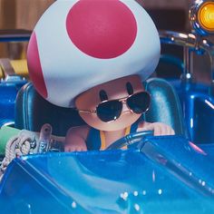 a person in a car with a mushroom hat and sunglasses