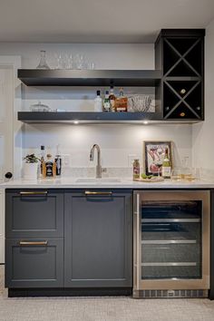 a kitchen with black cabinets and white counter tops