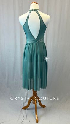 Sage Green mid length dress has high neck and key hold cutout in back. Front of bodice has alternating "stripes" of lycra and mesh. Skirt is attached. Gold floral appliqué on left chest and right hip. 2 Gross of Light Colorado Topaz 5ss, 7ss, 9ss, 12ss, 16ss, 20ss, and 30ss, and Chrysolite 9ss Rhinestones! ****Costume is photographed on Adult AS/AM mannequin measuring: Bust 35"; Waist 25"; Hips 34", Girth 57"**** Sheer Stretch Prom Dresses, Stretch Evening Dancewear Dress, Fitted Bodice Dancewear Dress For Party, Party Dress With Fitted Bodice Dancewear Style, Stretch Dresses For Night Out Dancewear, Stretch Dancewear Dress For Night Out, Stretch Dress With Sheer Back And Backless Design, Stretch Backless Dress With Sheer Back, Evening Dresses With Mesh Back And Stretch