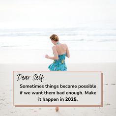 a woman in a blue dress walking on the beach with a sign saying dear self