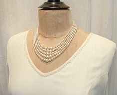 "Offering the most beautiful VERY well made antique Art Deco light champagne/rich ivory multi strand glass pearl and pave rhinestone statement necklace perfect for the Bride. The five strands of lustrous glass pearls used on this necklace are graduated in size and have unbelievable luster. Glass pearls mimic natural pearls in weight and luster. The strands come together with a gorgeous, SO Art Deco, large ornate rhodium plated clasp that is pave set with round cut BRILLIANTLY clear sparkly cryst Classic Cream Wedding Jewelry, Antique Pearl Drop Necklace For Wedding, Vintage Pearl Drop Necklace For Formal, Vintage Pearl Pendant Necklace, Elegant Cream Pearl Necklace For Formal Occasions, Vintage Pearl Drop Necklace For Evening, Antique Pearl Wedding Necklace, Vintage Pearl Drop Necklace For Formal Occasions, Vintage Pearl Drop Necklace For Wedding