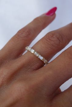 a woman's hand with a diamond ring on it