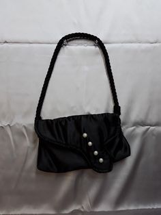 "This day or evening black satin 1950's retro style bag has pearlescent button accents and is very lightweight w/ a magnetic snap closure.  It measures approx 6\" by 10\" and has a shoulder strap made of black twisted rope that hangs approx 9\".  The lining is silver satin." Black Evening Shoulder Bag With Pearl Handle, Formal Black Shoulder Bag With Pearl Handle, Black Formal Evening Bag With Pearl Handle, Formal Black Evening Bag With Pearl Handle, Elegant Party Shoulder Bag With Snap Closure, Vintage Evening Shoulder Bag With Pearl Handle, Satin Noir, Retro Stil, Clutch Handbag