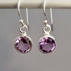 💖  Product Description Small Round 8mm Facetted Amethyst Earrings - A light purple Gemstone Dangly Earrings set in 925 Sterling Silver.  Great Dainty pair of earrings, very suitable for young girls as well as women Amethyst is the February Birthstone and 6th Anniversary Gemstone 💖 Product Details *  925 Sterling Silver *  Handmade *  Total Drop (Incl Hook) - 24mm *  Total Drop (Excl Hook) - 12mm *  Width at the widest point - 9mm *  Depth - 4mm *  Weight - 2.5g *  Stone Size - 8mm Diameter 💖  Packaging All items come in a pretty little gift bag made from Recycled saris.  If your earrings are a gift, then please do advise of colour preferences and we will do our best to send out a colour of choice.  For gemstone earrings, we do try and match the colour of the bag with the corresponding g 6th Anniversary Gifts, 6th Anniversary, February Birthstone, 925 Silver Earrings, Dangly Earrings, Amethyst Earrings, February Birth Stone, Fine Jewellery Earrings, Pendant Set