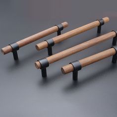 four black and wood handles on a gray surface