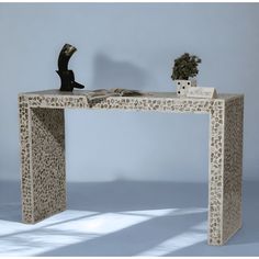 an animal print desk with a book and vase on it