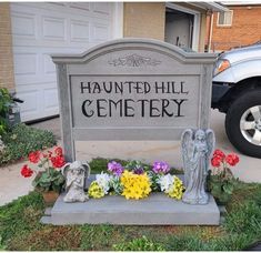 a cemetery sign with flowers in front of it