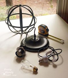 an assortment of electrical equipment sitting on a table next to a window with trees in the background