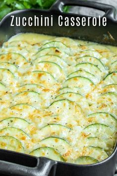 a casserole dish with zucchini and cheese in it on a table