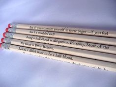 four pencils with writing on them sitting next to each other