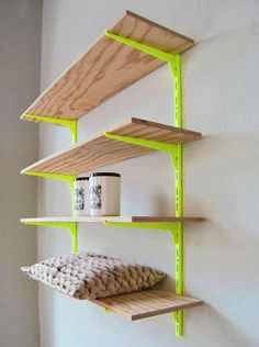 three wooden shelves on the wall, one with a mug and two without ones in it