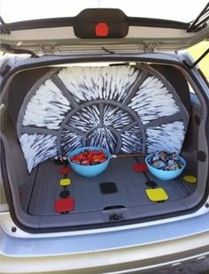 the back end of a car with two bowls of food in it's trunk