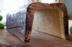 a piece of cheese sitting on top of a wooden table