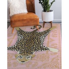 a leopard print rug with a chair and potted plant