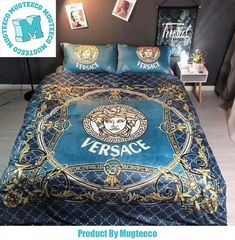 a bed covered in blue and gold bedspread with versa logo on the front