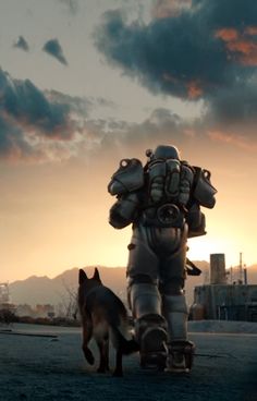 a dog standing next to a giant robot in the middle of a field at sunset