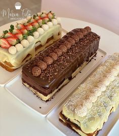 three desserts are arranged on separate white trays, one with chocolate and the other topped with strawberries