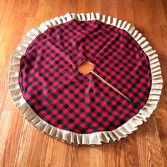 a red and black checkered cloth with a wooden spoon in it on the floor