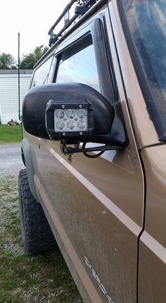 a close up of the side view mirror on a vehicle with its lights turned on