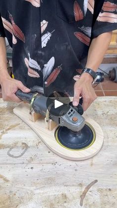 a person using a sander on a wooden board