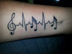 a tattoo with musical notes on it