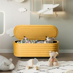 a yellow toy chest sitting on top of a white rug