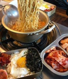 an assortment of food items displayed in metal containers