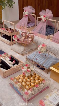 a table topped with lots of different types of cakes and desserts covered in pink tulle