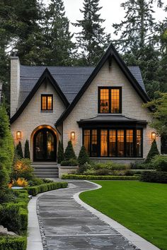 a large house with lots of windows in the front yard and walkway leading up to it