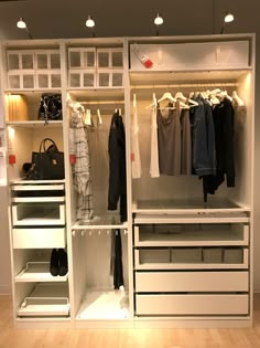 an organized closet with clothes and handbags