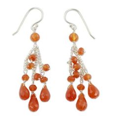 Carnelian droplets fall into a mesmerizing cascade in sumptuous handcrafted earrings. By Rituu the faceted gems are suspended from sleek sterling chains. .925 Sterling silver Orange Gemstone Drop Jewelry, Orange Drop Gemstone Jewelry, Orange Gemstone Dangle Jewelry, Orange Dangle Pierced Jewelry, Silver Gemstone Chandelier Drop Earrings, Silver Gemstone Drop Chandelier Earrings, Silver Carnelian Drop Earrings, Elegant Carnelian Dangle Earrings, Sterling Silver Long Drop Jewelry With Dangling Beads