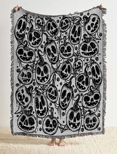 a black and white tapestry with skulls on it