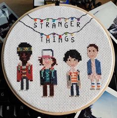 a cross stitch pattern with the words, strange things on it and three people standing in front of them